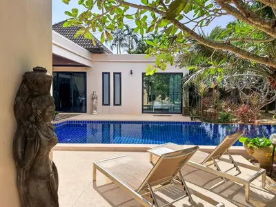 a patio with two chairs and a swimming pool at Villa Intira 5 bedrooms with 12m private pool and garden in Rawai Beach