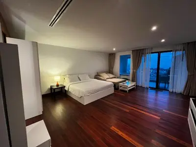 a bedroom with a bed and a couch in it at Thebirdhouse Patong Phuket201 in Patong Beach
