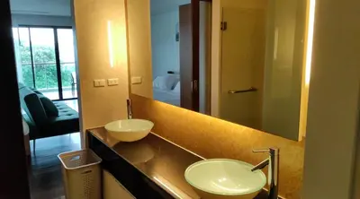 a bathroom with two sinks and a large mirror at Thebirdhouse Patong Phuket201 in Patong Beach