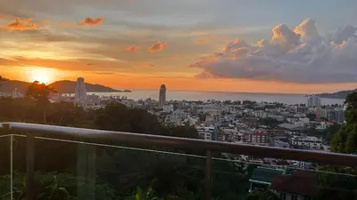 a view of a city at sunset at Thebirdhouse Patong Phuket201 in Patong Beach