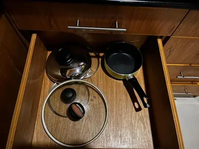 a wooden drawer with some utensils and a strainer at Thebirdhouse Patong Phuket201 in Patong Beach