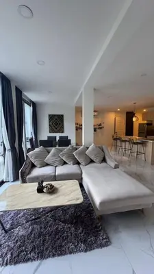 a living room with a large couch and a table at New Years Super Fancy 2br Villa near Cafe Del Mar in Kamala Beach