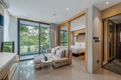 a living room with a couch and a bed at C225 City Gate Kamala Great facilities 600m to beach in Kamala Beach