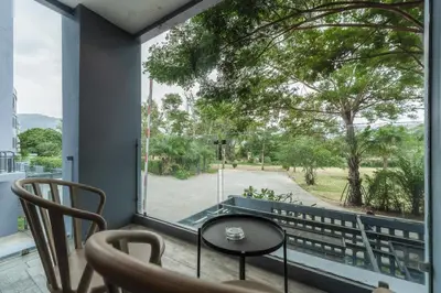 a balcony with a table and chairs and a large window at C225 City Gate Kamala Great facilities 600m to beach in Kamala Beach