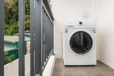 a washing machine in a room with a window at C169 Part of the famous Fantasea Kamala in Kamala Beach