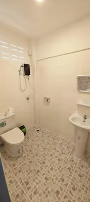 a bathroom with a toilet and a sink at Tiger Nanai guest house in Patong Beach