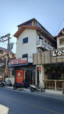 a group of scooters parked in front of a building at Tiger Nanai guest house in Patong Beach
