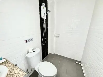a bathroom with a toilet and a phone on the wall at Patong Easy Life 7 in Patong Beach
