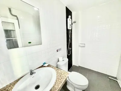 a white bathroom with a sink and a toilet at Patong Easy Life 7 in Patong Beach
