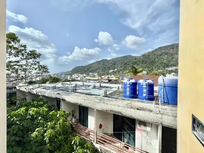 a building with blue water tanks on the roof at Patong Easy Life 7 in Patong Beach
