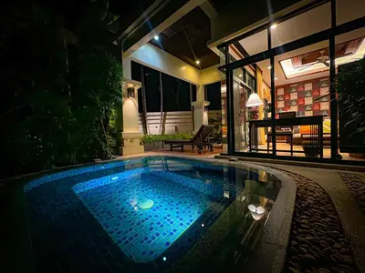 a swimming pool in the middle of a house at night at Rose Pool Villa The perfect private oasis in Rawai Beach