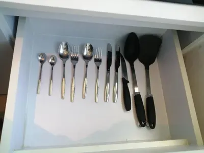 a drawer with silver utensils in a white drawer at Utopia Central Kathu Condo in Phuket Town