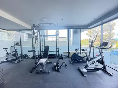 a gym with a bunch of exercise bikes and treadmills at Utopia Central Kathu Condo in Phuket Town