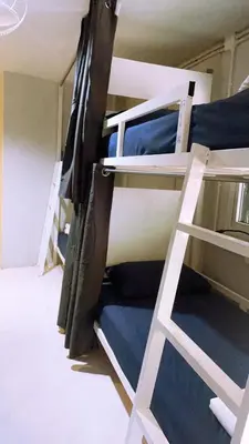 a room with two bunk beds and a ladder at Babyshark Hostel - Loh Dalum Bay in Phi Phi Don