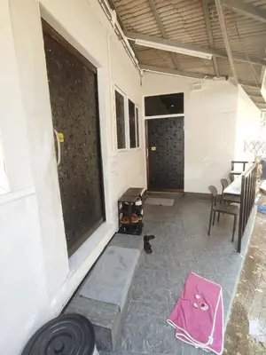 a room with a table and chairs and a window at Babyshark Hostel - Loh Dalum Bay in Phi Phi Don