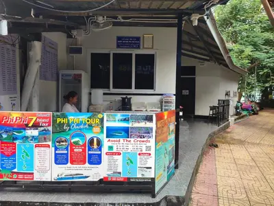 a gas station with posters on the side of it at Babyshark Hostel - Loh Dalum Bay in Phi Phi Don