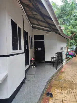 a patio of a house with a table and chairs at Babyshark Hostel - Loh Dalum Bay in Phi Phi Don