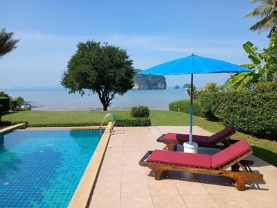 a pool with two lounge chairs and an umbrella at OMG !! Amazing Sea Views !! Stunning Sunsets !! Khao Thong Krabi Thailand in Ban Khao Thong