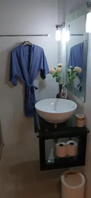 a sink in a bathroom with a blue shirt and a mirror at OMG !! Amazing Sea Views !! Stunning Sunsets !! Khao Thong Krabi Thailand in Ban Khao Thong