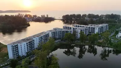 an aerial view of a river with apartment buildings at Cassia Residences 1BDR Lake view in Laguna Phuket