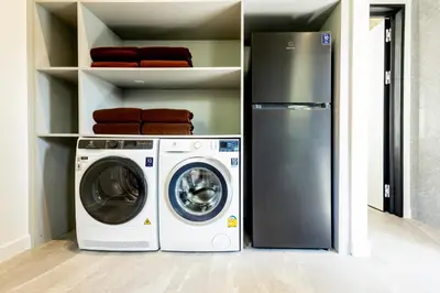 a laundry room with a washer and a refrigerator at Luxury 4 Bedroom Villa 1 Minute from Laguna Phuket in Bang Tao Beach