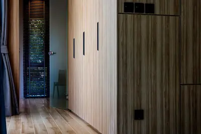 a hallway with a wooden door in a room at Luxury 4 Bedroom Villa 1 Minute from Laguna Phuket in Bang Tao Beach