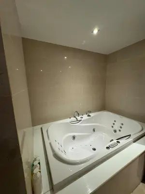 a bath tub in a bathroom with a tub at Privilège résidence patong in Patong Beach