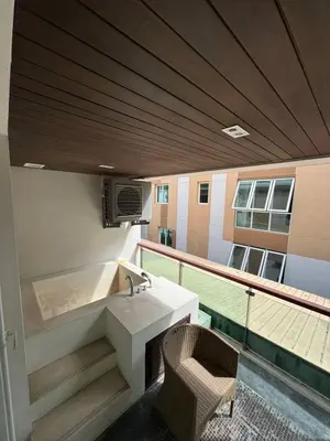 a balcony with a sink and a chair at Privilège résidence patong in Patong Beach