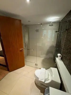 a bathroom with a shower and a toilet and a tub at Privilège résidence patong in Patong Beach