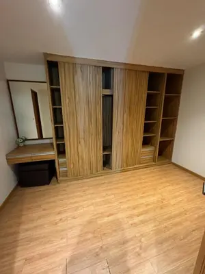 an empty room with wooden shelves and wooden floors at Privilège résidence patong in Patong Beach