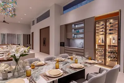 a dining room with a long table and chairs at Villa AMANN in Phuket Town