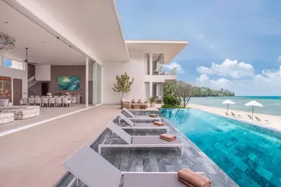an open living room with a swimming pool and the ocean at Villa AMANN in Phuket Town