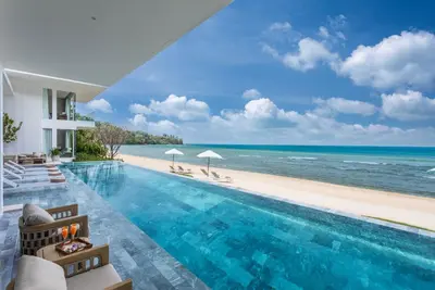a pool with a view of the beach at Villa AMANN in Phuket Town