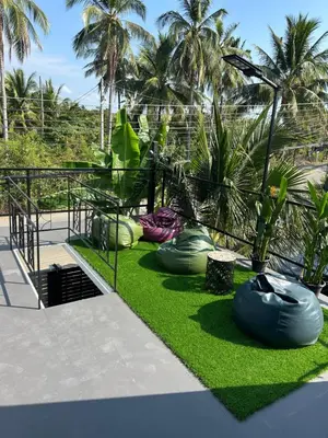 a garden with inflatable objects on the grass at Rawai Beach studio in Nai Harn Beach