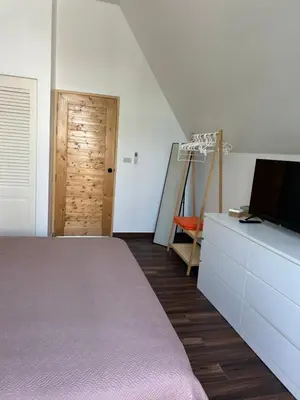 a bedroom with a bed and a dresser with a television at Rawai Beach studio in Nai Harn Beach