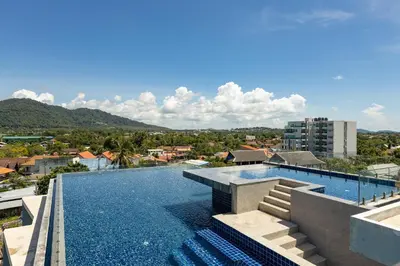 a swimming pool on the roof of a building at ReLife The Windy Condo B218 Naiharn in Rawai Beach