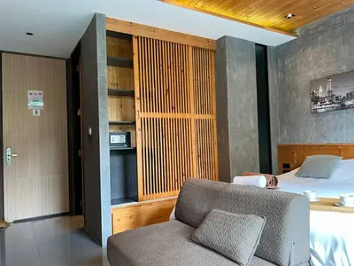 a bedroom with a bed and a couch in a room at ReLife The Windy Condo B218 Naiharn in Rawai Beach