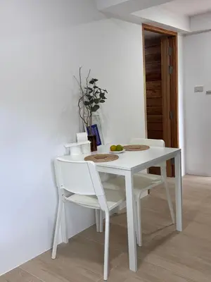 a white table and chairs in a room at Cozy room Maikhao Phuket in Ban Ao Tu Khun