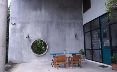 a blue table and chairs in front of a building at Cozy room Maikhao Phuket in Ban Ao Tu Khun