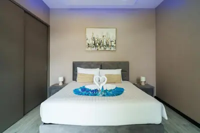 a bedroom with a bed with two towels on it at Diamond 2 Villa by G Estate Phuket in Ban Saiyuan (1)
