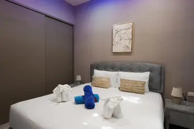 a bedroom with a bed with towel animals on it at Diamond 2 Villa by G Estate Phuket in Ban Saiyuan (1)