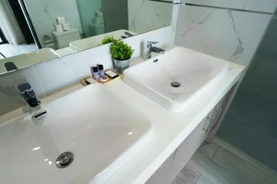 a bathroom with a white sink and a mirror at Diamond 2 Villa by G Estate Phuket in Ban Saiyuan (1)