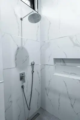 a shower in a bathroom with white marble walls at Diamond 2 Villa by G Estate Phuket in Ban Saiyuan (1)