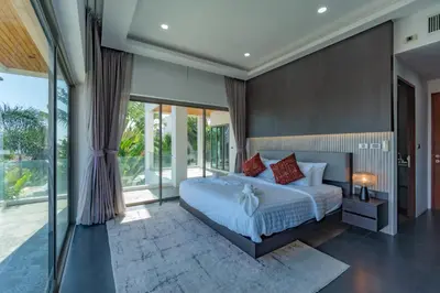 a bedroom with a large white bed with red pillows at Luxury Seaview Villa 6BR - Villa Shine in Ban Saiyuan (1)