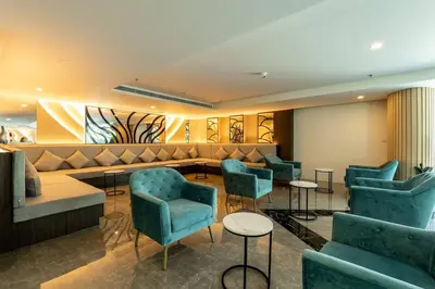 a waiting room with blue chairs and a couch at 1Bd Сomfortable Apartment LaVita in Phuket Town