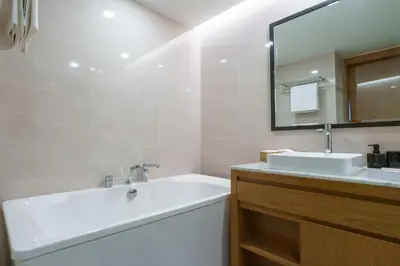 a white bathroom with a sink and a mirror at 1Bd Сomfortable Apartment LaVita in Phuket Town