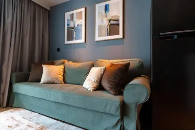 a living room with a couch with pillows on it at 1Bd Сomfortable Apartment LaVita in Phuket Town