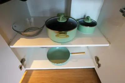 a cupboard with two pots and a bowl at 1Bd Сomfortable Apartment LaVita in Phuket Town