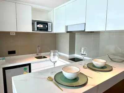 a kitchen with two bowls and wine glasses on a counter at 1Bd Сomfortable Apartment LaVita in Phuket Town
