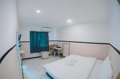 a hospital room with a bed and a blue curtain at XX Mitr Inn Phuket Old Town -มิตร อินน์ ภูเก็ตโอลทาวน์ in Phuket Town